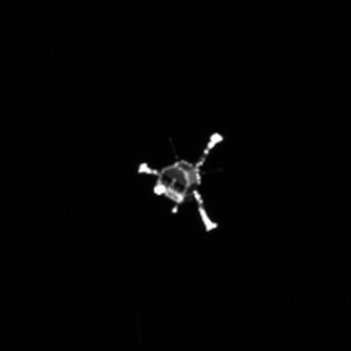 Philae im Sinkflug Verschwommene Aufnahme eines kleinen Raumfahrzeugs mit drei Beinen.