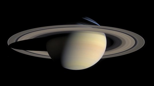 Der Planet Saturn mit seinen charakteristischen Ringen im All