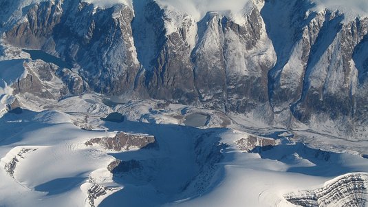 Gebirgslandschaft mit schneebedeckten Flächen dazwischen