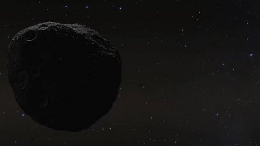 Ein dunkler, steiniger Himmelskörper im dunklen All