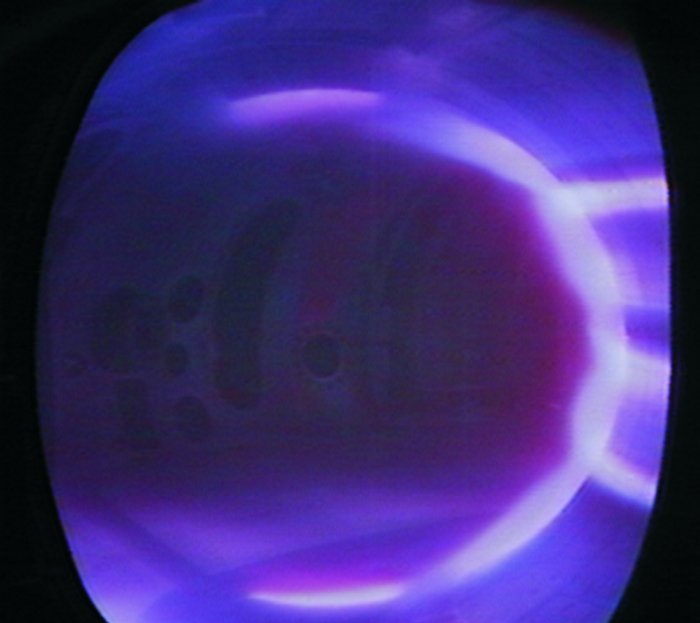 Bläulich leuchtendes Plasma im Inneren der Tokamak-Röhre.