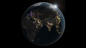 Ein Blick vom All auf die Erde: Man sieht die Kontinente Afrika, Asien und Europa im Dunklen. Lichtpunkte zeigen künstliche Beleuchtung - an einigen Ballungszentren gibt es sehr viele, anderen Orten wenige bis keine. 
