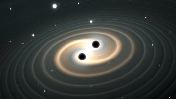 Die Abbildung zeigt zwei schwarze Kreise, um die herum sich spiralförmig Wellen ausbreiten.