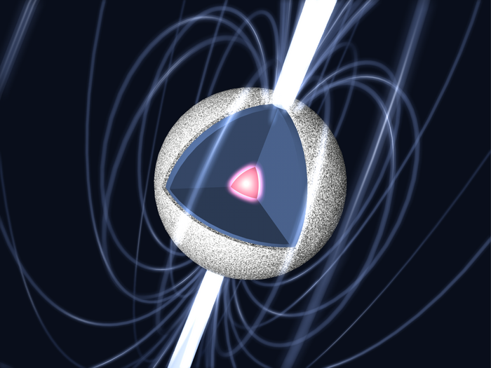Gezeigt ist die künstlerische Darstellung eines Neutronensterns. Umgeben wird dieser von Magnetfeldlinien; aus seinen magnetischen Polen schießt jeweils ein gebündelter Materiestrahl. In der Illustration ist der Neutronenstern aufgeschnitten, sodass man in das Innere und auf seinen Kern blicken kann.