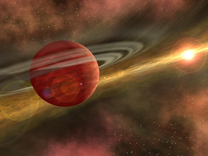 Planetenentstehung Planet von dünnen Ringen umgeben, rechts im Hintergrund eine helle Lichtquelle.