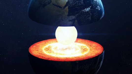 Eine aufgeschnittene Erde, bei der im Inneren ein hell leuchtender Erdkern zum Vorschein kommt.