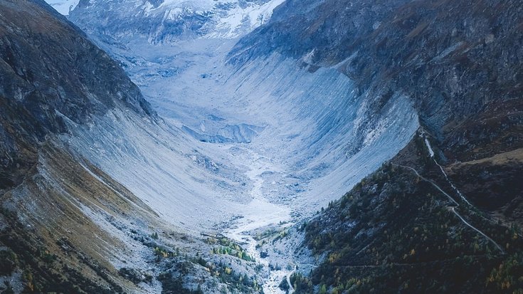 Enges Tal in einer felsigen Berglandschaft, durch das ein Fluss fließt