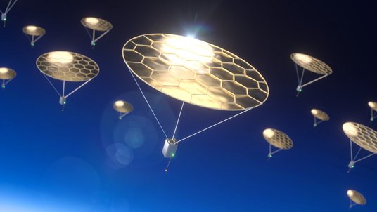 Kleine Flugobjekte am Himmel mit metallisch glänzenden Scheiben, an denen sie aufgehängt sind