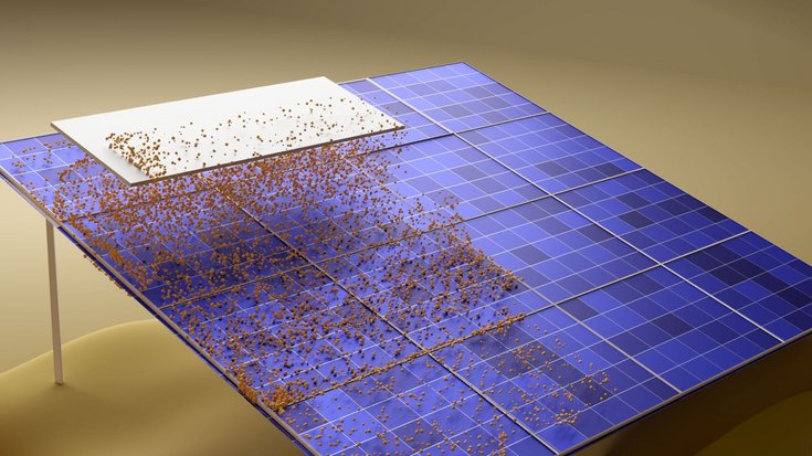 Solarmodul, auf dessen linker Fläche sich orange Kügelchen befinden, die auf der rechten Seite fehlen; im oberen Bereich liegt auf den Solarzellen eine weiße Fläche auf