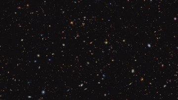 Viele helle Punkte verschiedener Größen auf dunklem Hintergrund